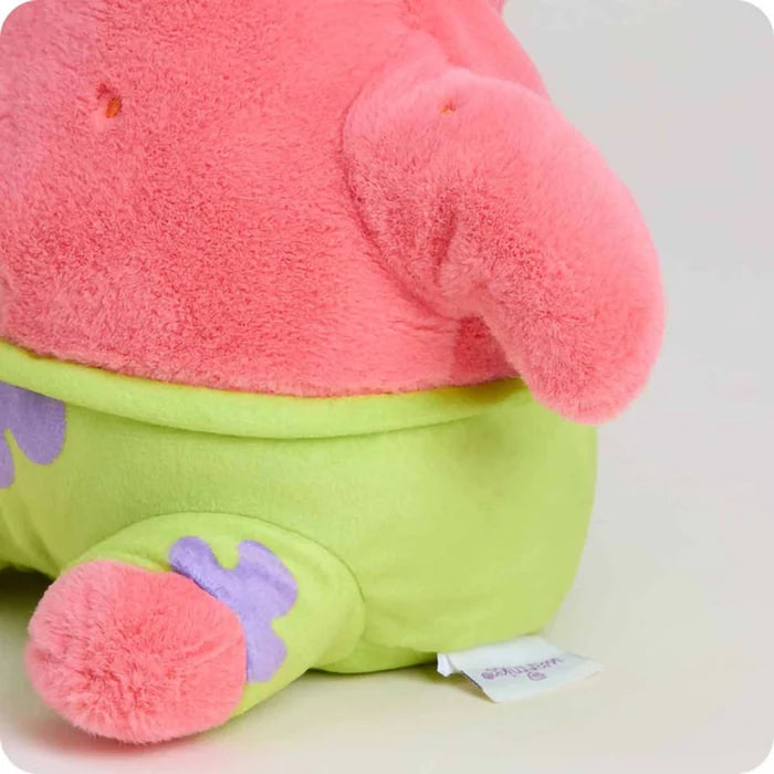 Close-up of Warmies Patrick Star plush showing textured pink fabric, green shorts, and stitched detailing