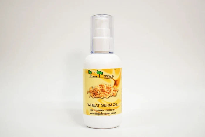 Bottle of wheat germ oil with a label on a white background