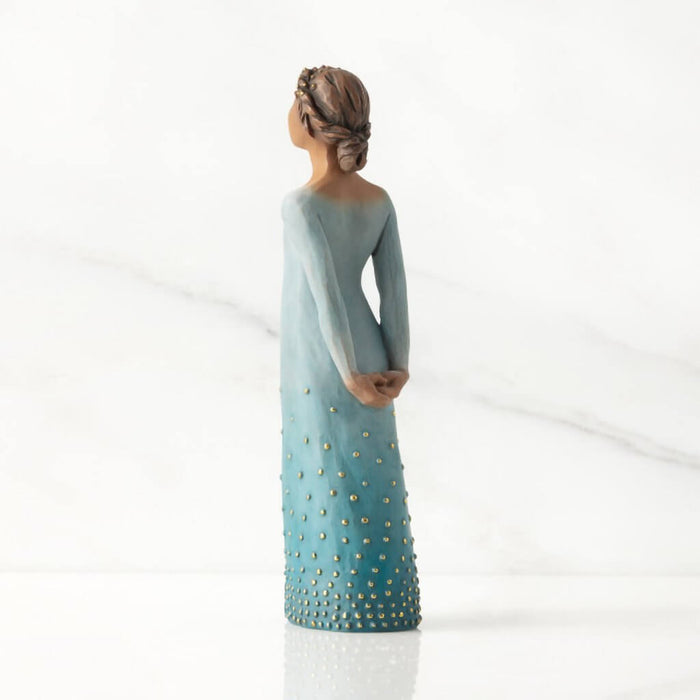 Willow Tree Radiance figurine with darker skin tone – hand-painted resin figure in ombré blue dress with gold accents, symbolizing strength and inner light.