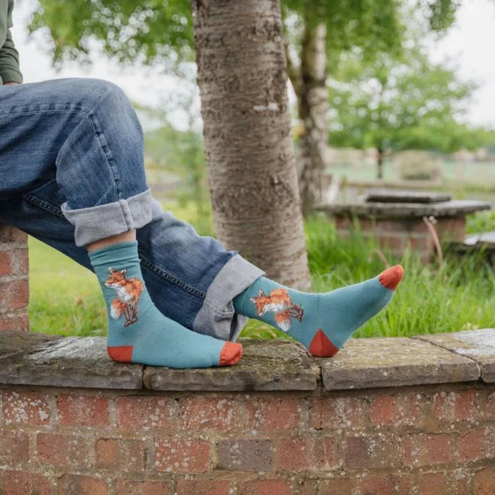 Colorful socks adorned with a whimsical fox illustration.
