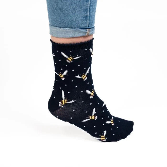 Colorful socks adorned with a whimsical bee design, showcasing multiple bees on a soft fabric.