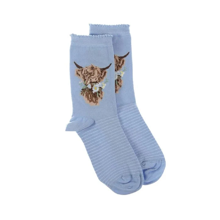 A pair of blue socks featuring a playful cow design.