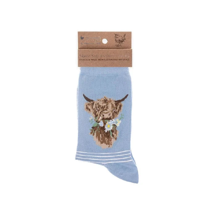A set of blue socks showcasing a cute cow illustration.
