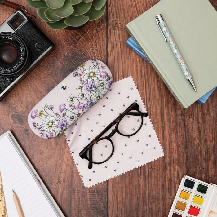 Wrendale Designs 'Just Bee-cause' bee eyeglass case with glasses, cleaning cloth, and stationery on wooden desk