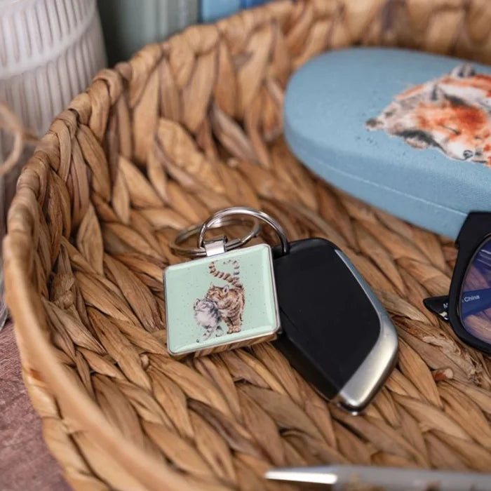 A basket filled with sunglasses, keys, and a decorative keyring for easy identification.
