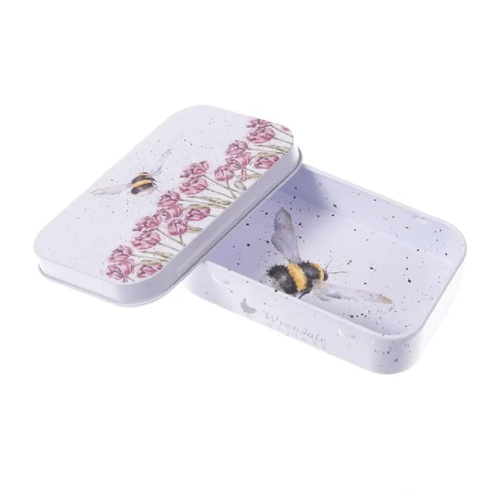 A small tin featuring a bee and colorful flowers, showcasing a charming nature-inspired design.