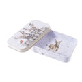 A small tin box featuring an illustration of a deer and a rabbit on its surface.