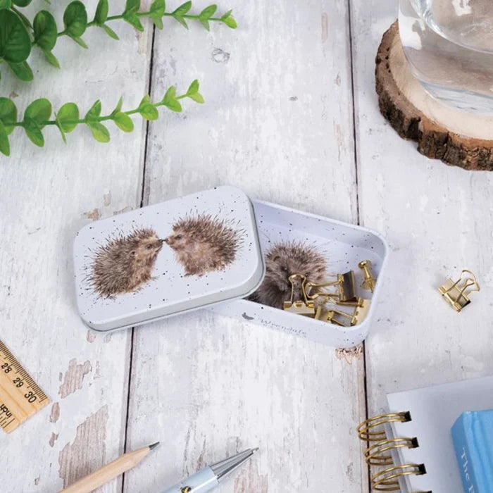 A tin box displaying a hedgehog illustration, emphasizing its playful and artistic design.