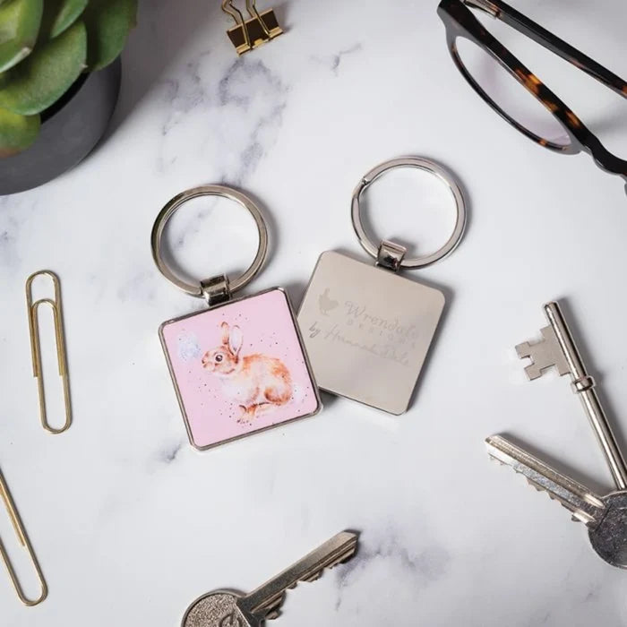 A pink keychain adorned with a rabbit, perfect for adding charm to your keyring.