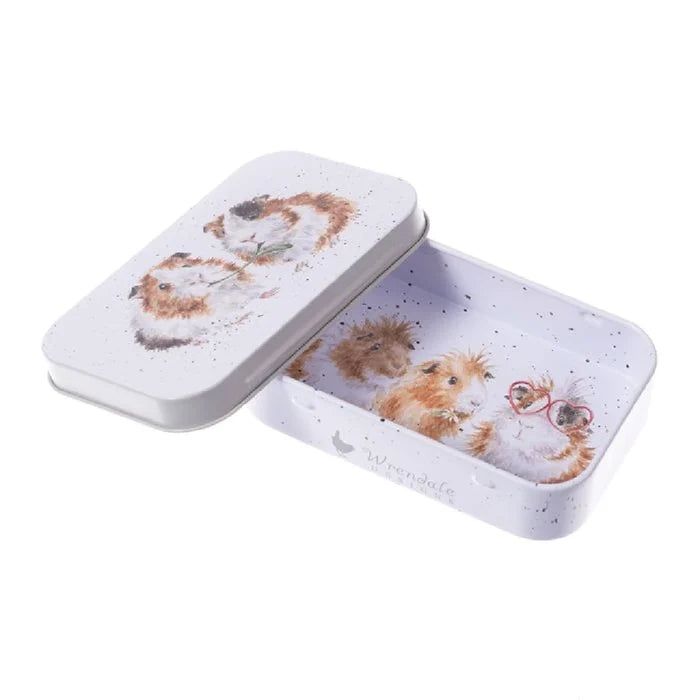 A decorative tin box featuring a whimsical cat design on its surface.