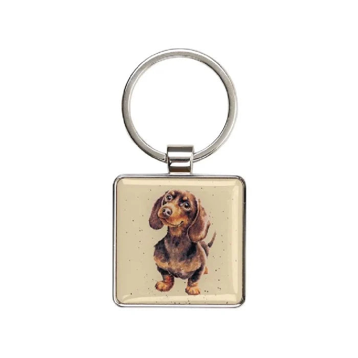 A dachshund dog is featured on a square key chain, showcasing its playful expression and distinctive long body.