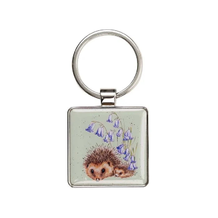 A square keychain featuring a hedgehog surrounded by delicate bluebells.
