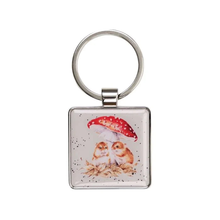 A square keychain featuring two owls standing together under a colorful umbrella.
