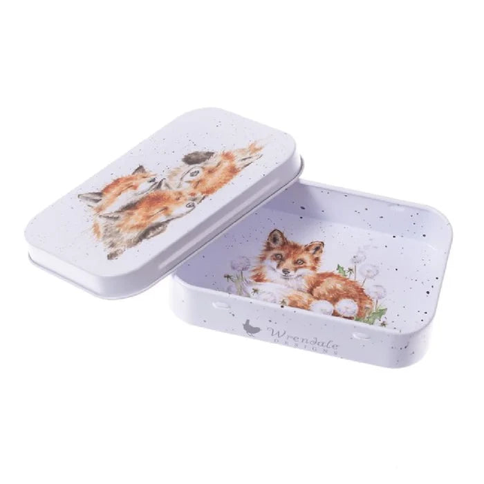 A small tin box featuring a whimsical fox design on its surface.