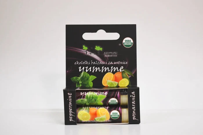 Packaging of Yumme lip balm with peppermint flavor on a white background