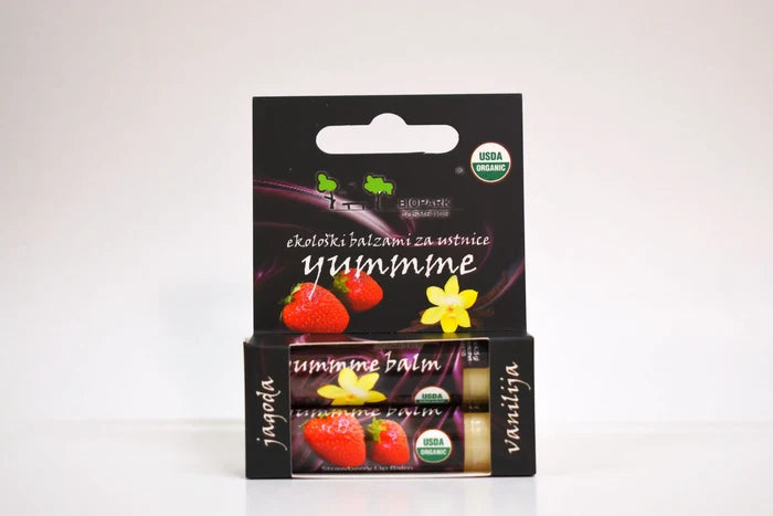 Yummie lip balm packaging with black background and colorful elements