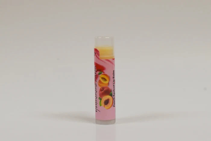 Lip balm with a colorful label featuring fruits on a white background