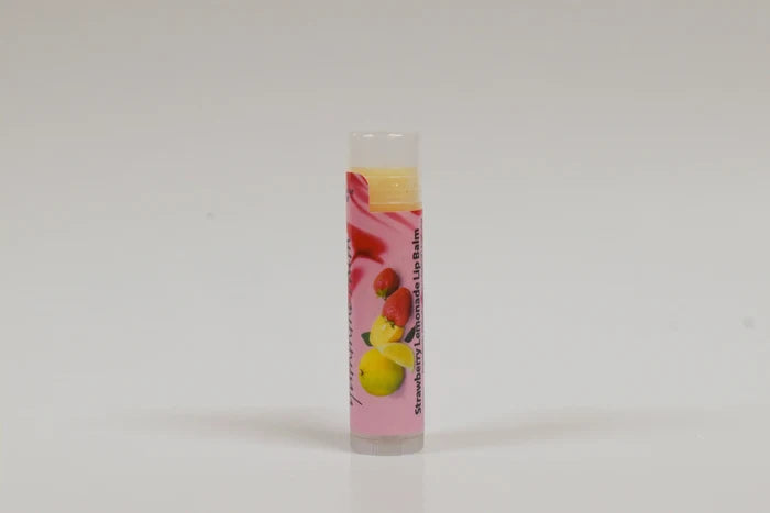 Lip balm with strawberry and lemon flavor on a white background